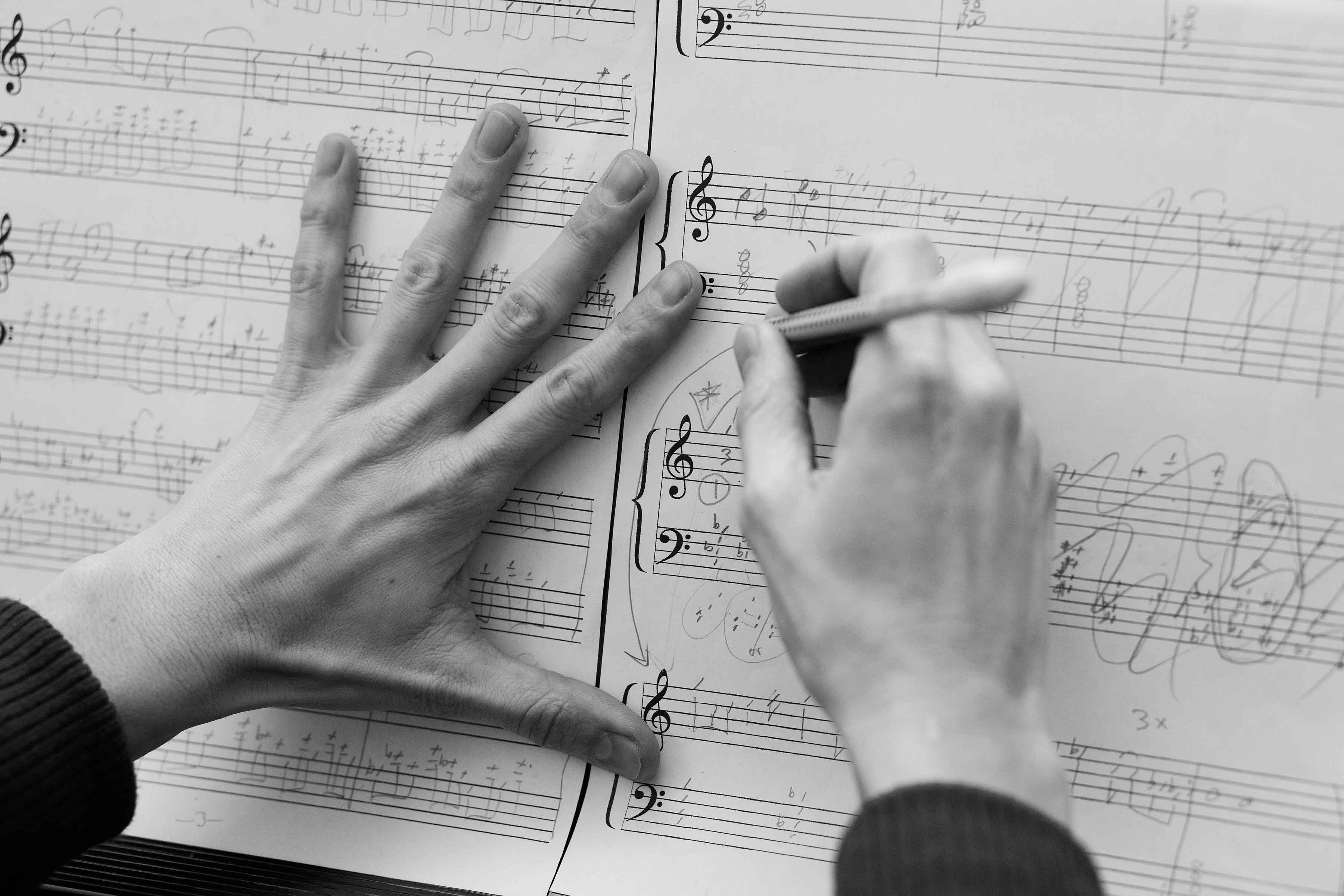 Eva writhing notes on a composition sheet